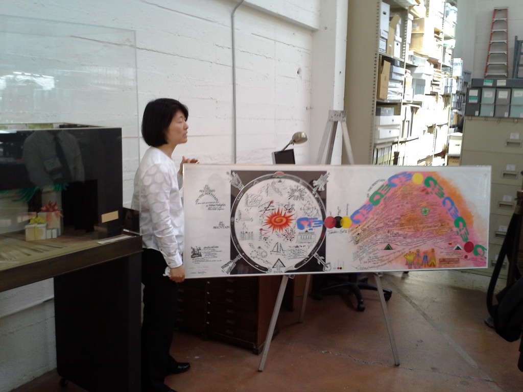 Kirsten Tanaka shows an Anna Halprin dance score for "In the Mountain On the Mountain" during the June 2015 tour of the Museum of Performance and Design. Photo by John Calhoun.